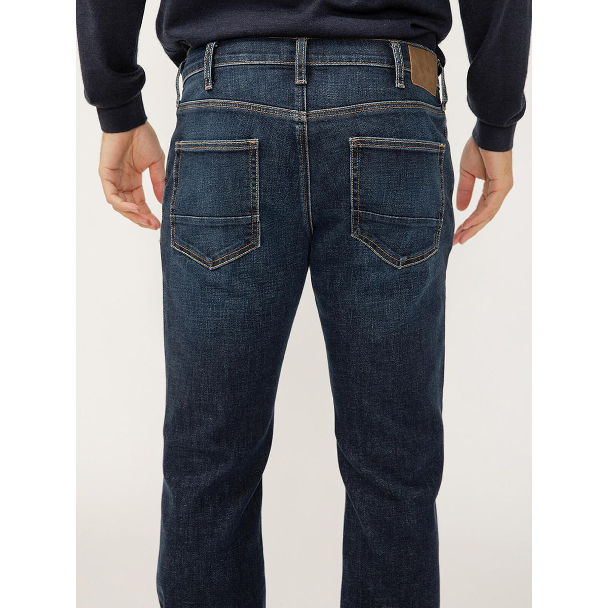 Back view of Silver Jace Slim Bootcut Luxe in Swing jeans in dark indigo Luxe Heritage denim with back pockets.