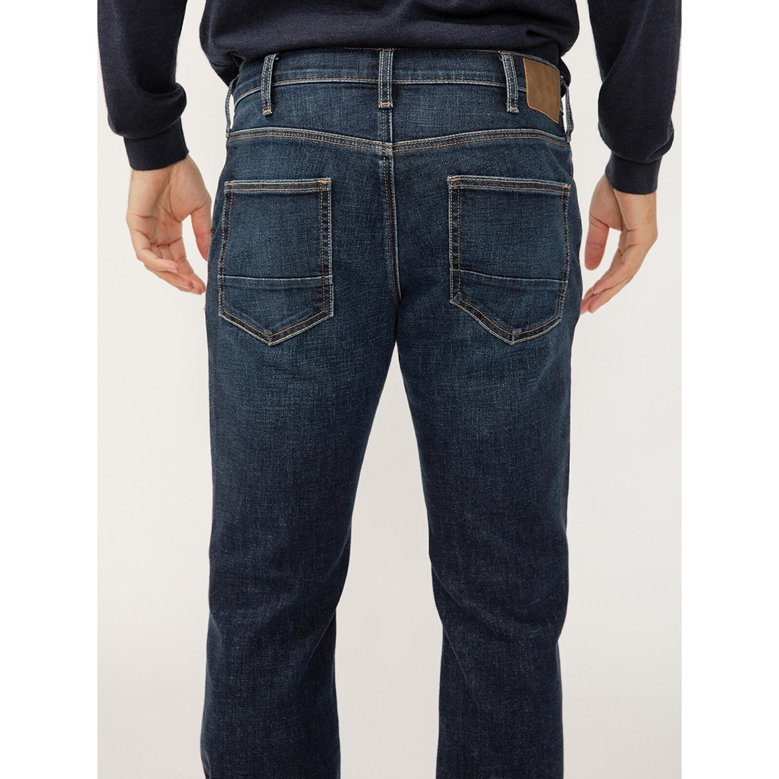 Back view of Silver Jace Slim Bootcut Luxe in Swing jeans in dark indigo Luxe Heritage denim with back pockets.