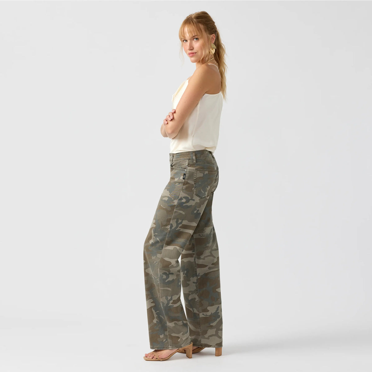 Side view of silver loose low camo jeans featuring a fitted low rise and wide-straight leg design.