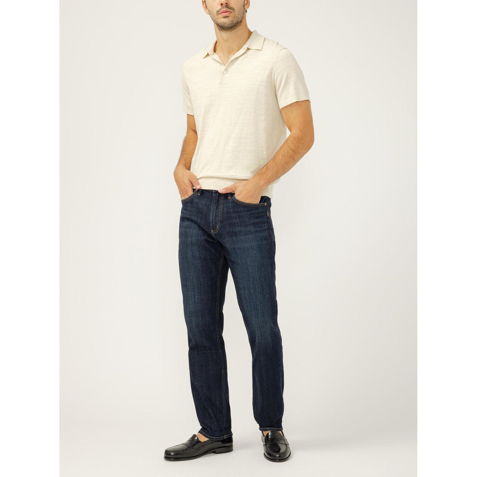 Silver Machray Slim Straight Leg in Twister jeans worn with a cream polo shirt.
