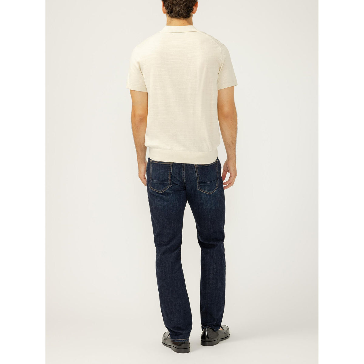 Back view of a model in Silver Machray Slim Straight Leg Twister jeans with a white shirt.