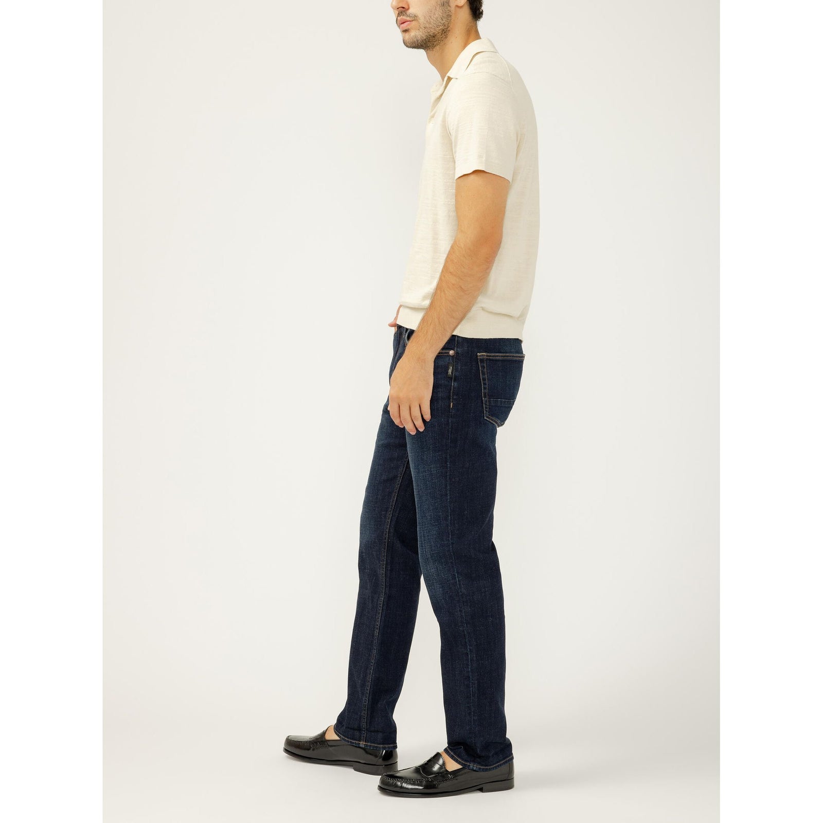 Male model wearing Silver Machray Slim Straight Leg jeans in Twister with a beige polo and loafers.