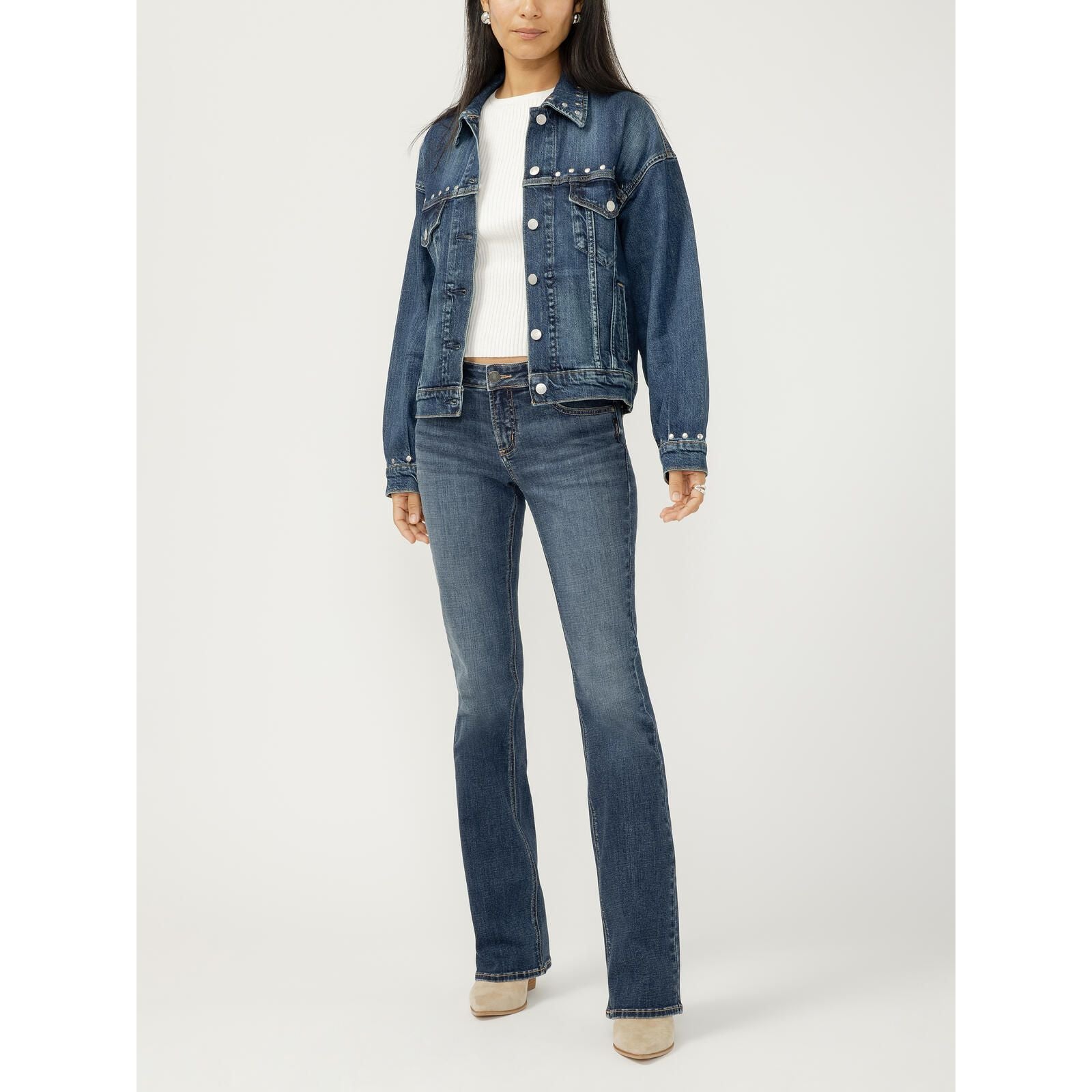 Model in a hand-studded silver denim jacket with a structured 90s fit, layered over a white knit top.