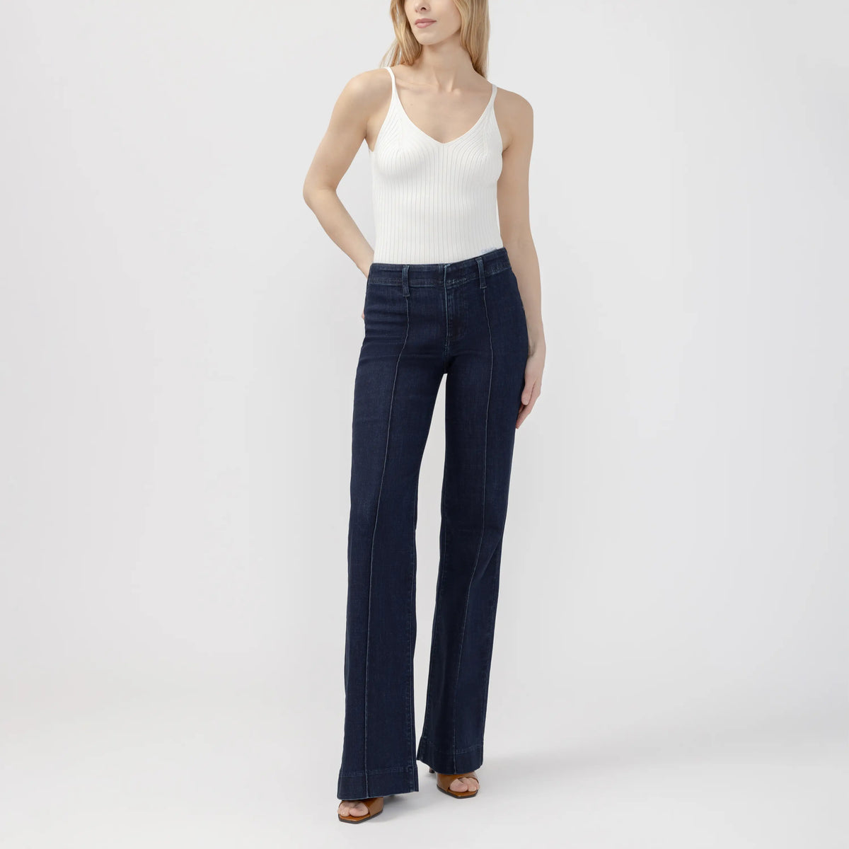 Dark wash Suki 70s trouser featuring a curvy fit, wide leg, and contoured waistband for a sleek, retro-inspired look.