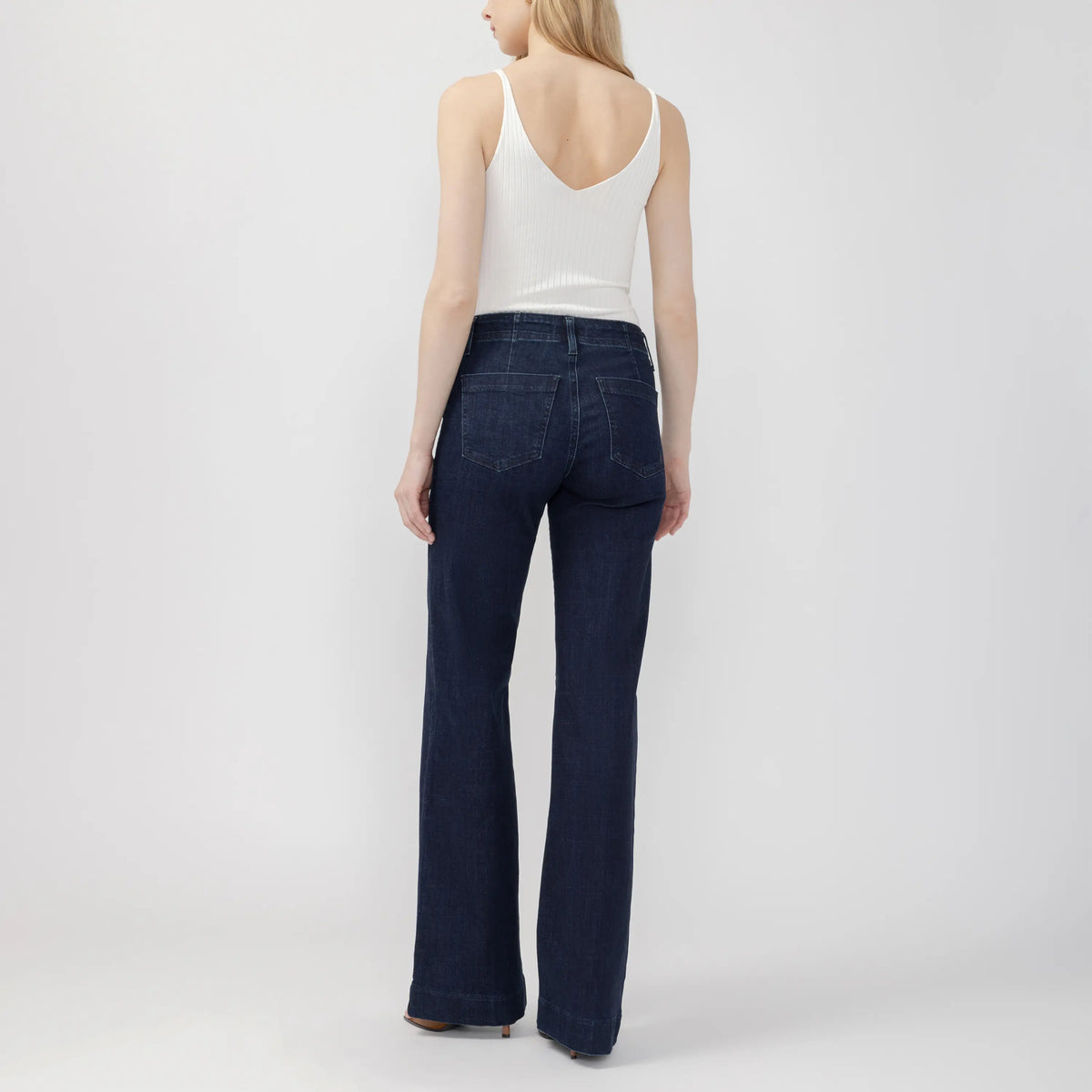 Back view of dark wash Suki 70s Trouser featuring a curvy fit, contoured waistband, and wide leg silhouette.