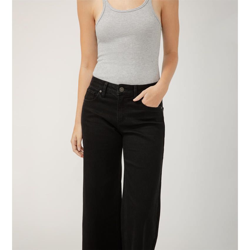 Stylish woman wearing Silver Suki Ankle Wide Leg Black jeans, showcasing luxe stretch denim and a mid-rise fit.