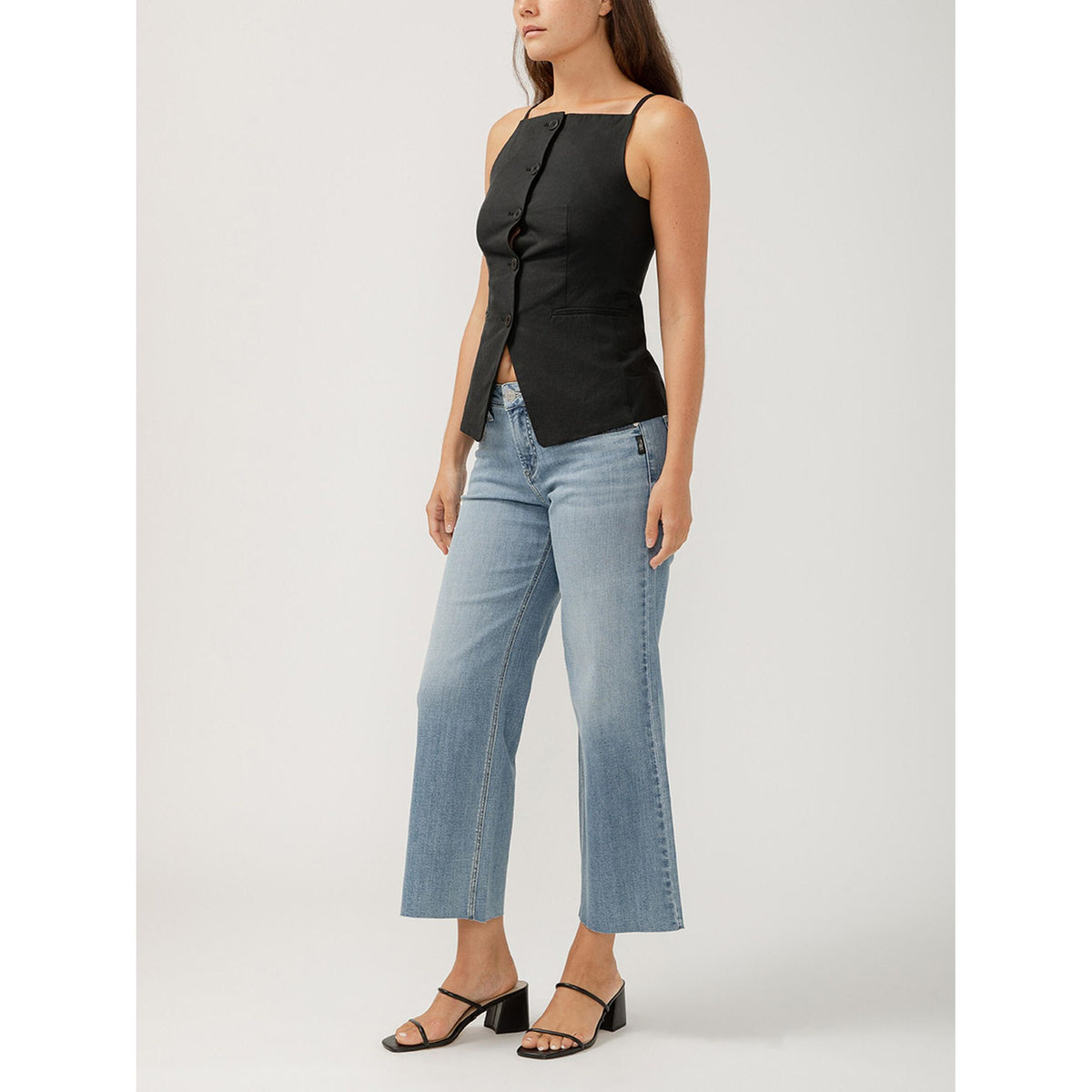 Model wearing Silver Suki ankle wide-leg indigo jeans with a black sleeveless top.
