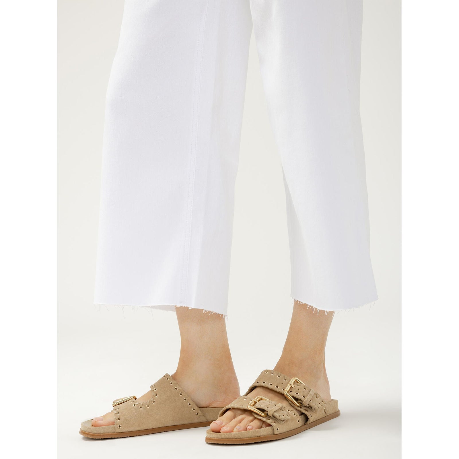 Silver Suki white wide-leg cropped jeans with frayed hem, shown with tan sandals.