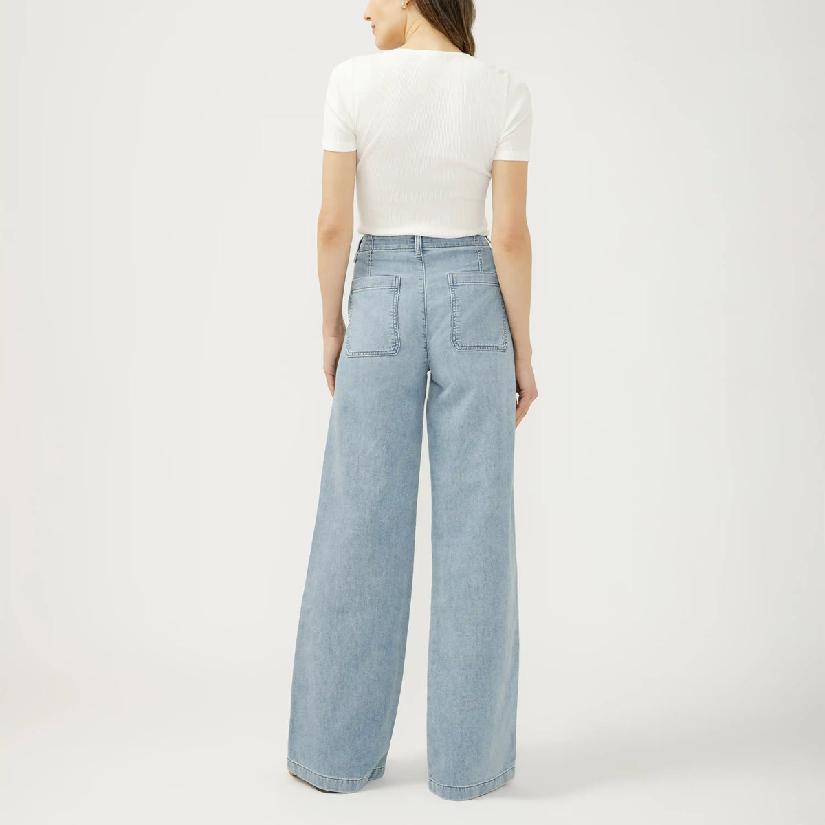Back view of silver wide leg knit flex denim jeans in Crickets wash, featuring a relaxed fit and clean hanging silhouette.