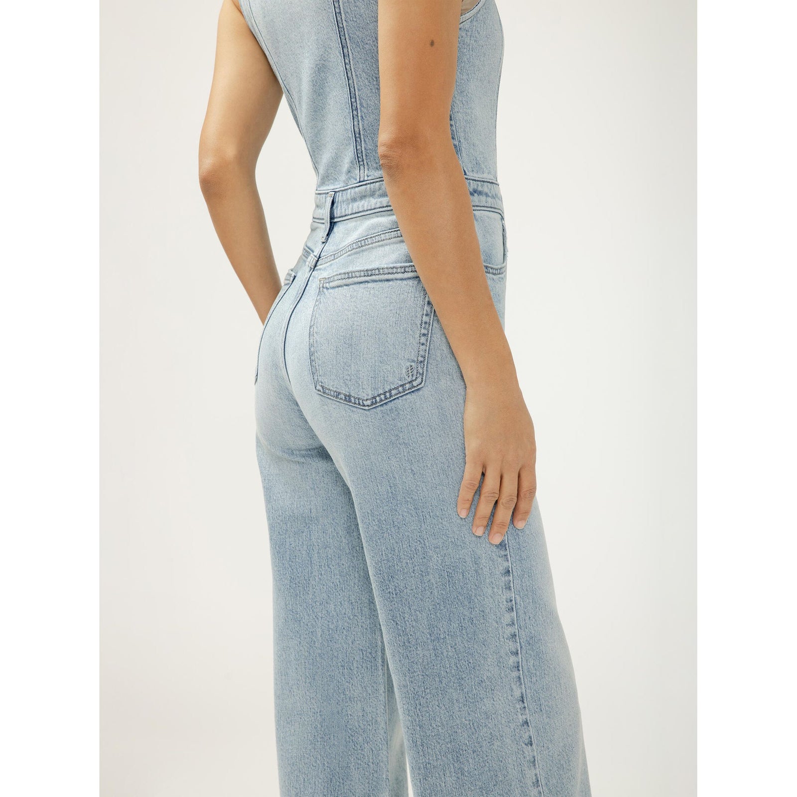 Back view of a silver wide-leg vest jumpsuit in Holbox with a structured denim vest silhouette.