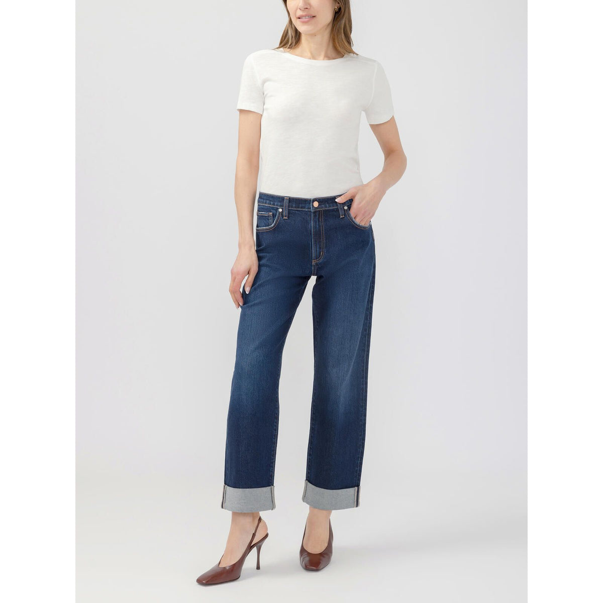 Model wearing Silver Willow relaxed straight leg Woolwich jeans with paperbag waist and cuffed hem, paired with a white tee and brown heels.