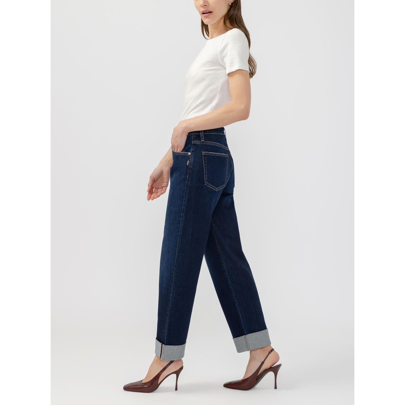 Dark wash Silver Willow relaxed straight leg jeans featuring a paperbag waist and cuffed hem, styled with brown heels.