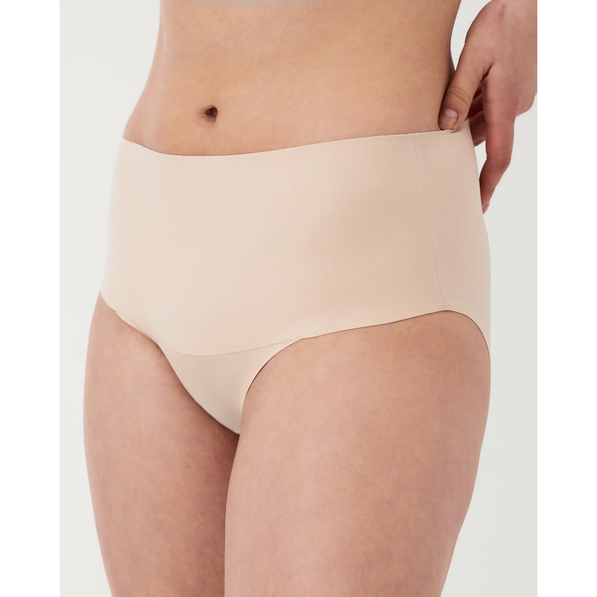 Spanx Undie-tectable Smoothing Brief on a model; bonded waistband, seamless edges for a smooth look under clothes.