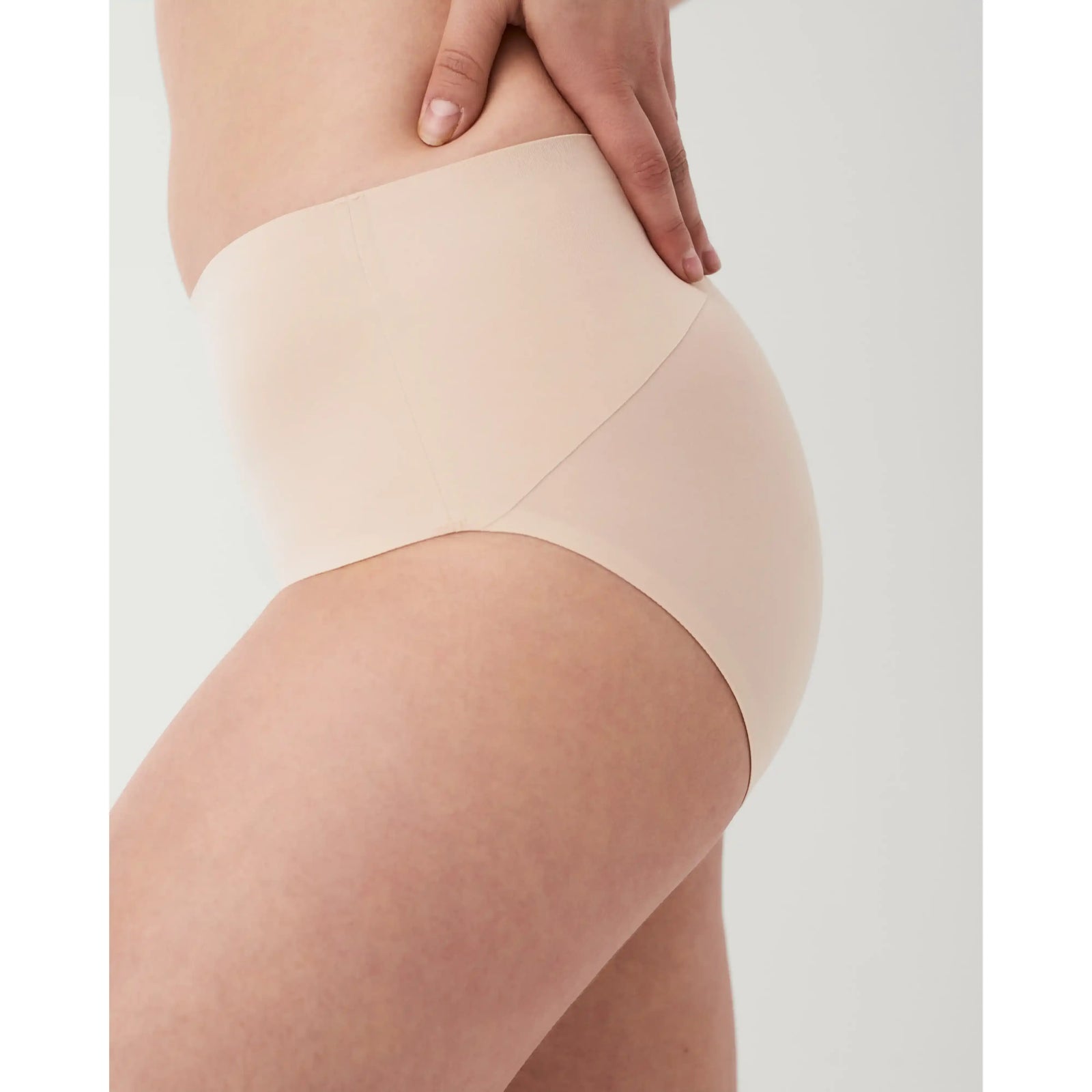 Spanx Undie-tectable smoothing brief on a side view; seamless edges provide no visible panty lines.