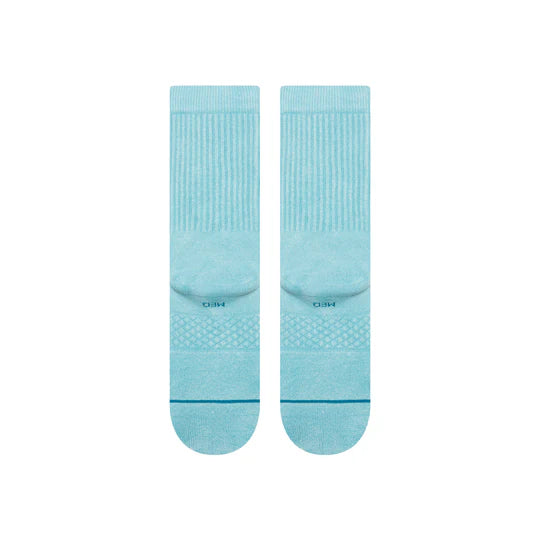 Pair of light blue Stance Icon Dyed Crew Socks with ribbed cuffs and seamless toe.