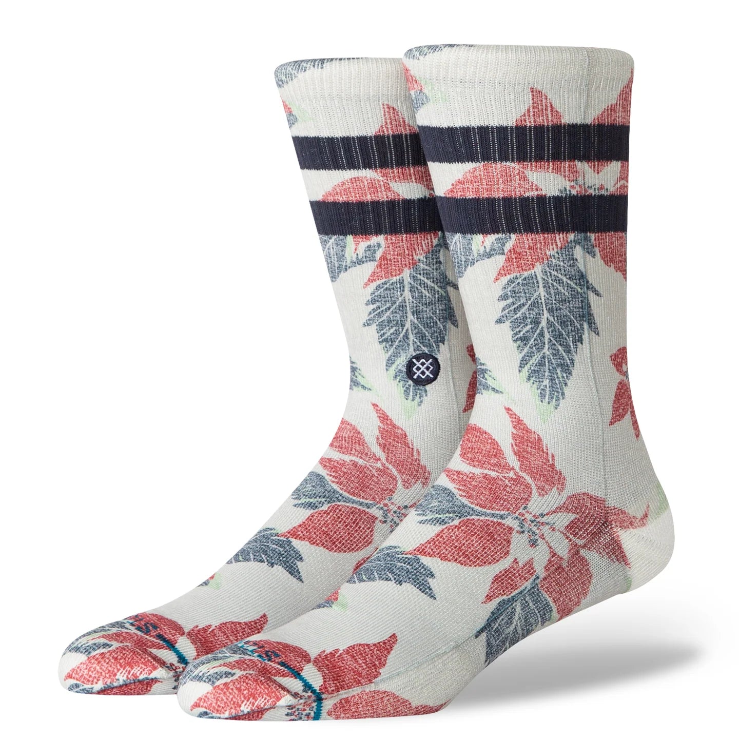 Grey Stance crew socks featuring bold red poinsettia graphics, blue leaf accents, and dark navy striped cuff for festive holiday style.