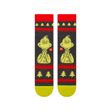 Black crew socks featuring a yellow Grinch graphic in a Santa outfit, surrounded by red Christmas trees and festive sweater-knit patterns.