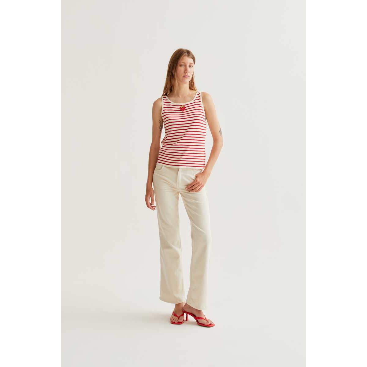 Strawberry on Red Stripes Tank on model: red striped viscose knit sleeveless top with strawberry graphic.