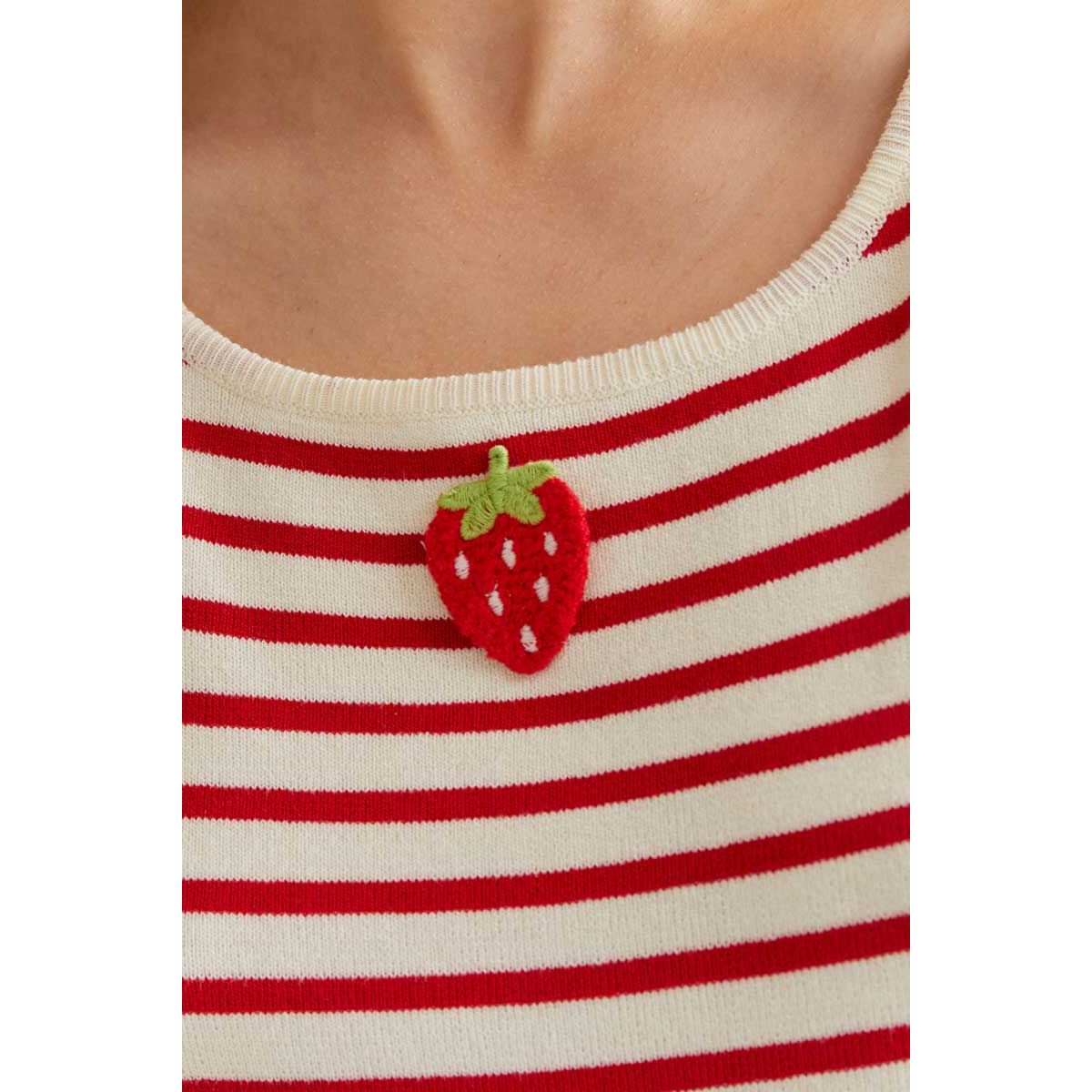 Strawberry applique on cream and red striped knit tank top neckline.