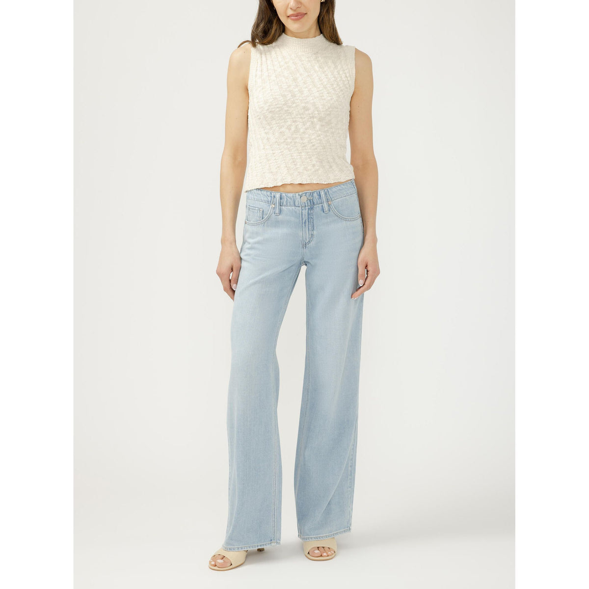Silver Suki Wide Leg inDreamer's Edge: model in light-wash wide-leg jeans and cream knitted sleeveless top
