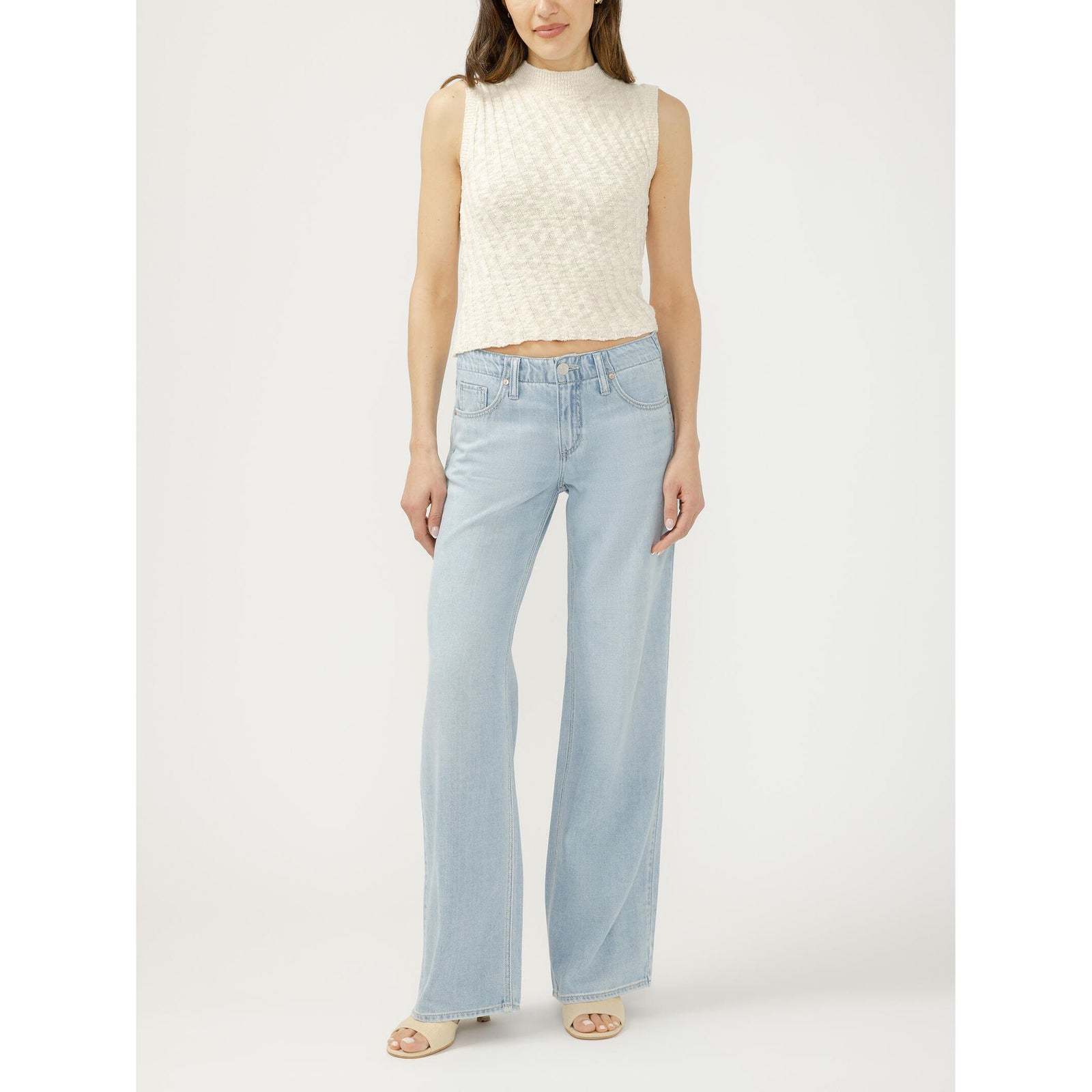 Silver Suki Wide Leg inDreamer's Edge: model in light-wash wide-leg jeans and cream knitted sleeveless top