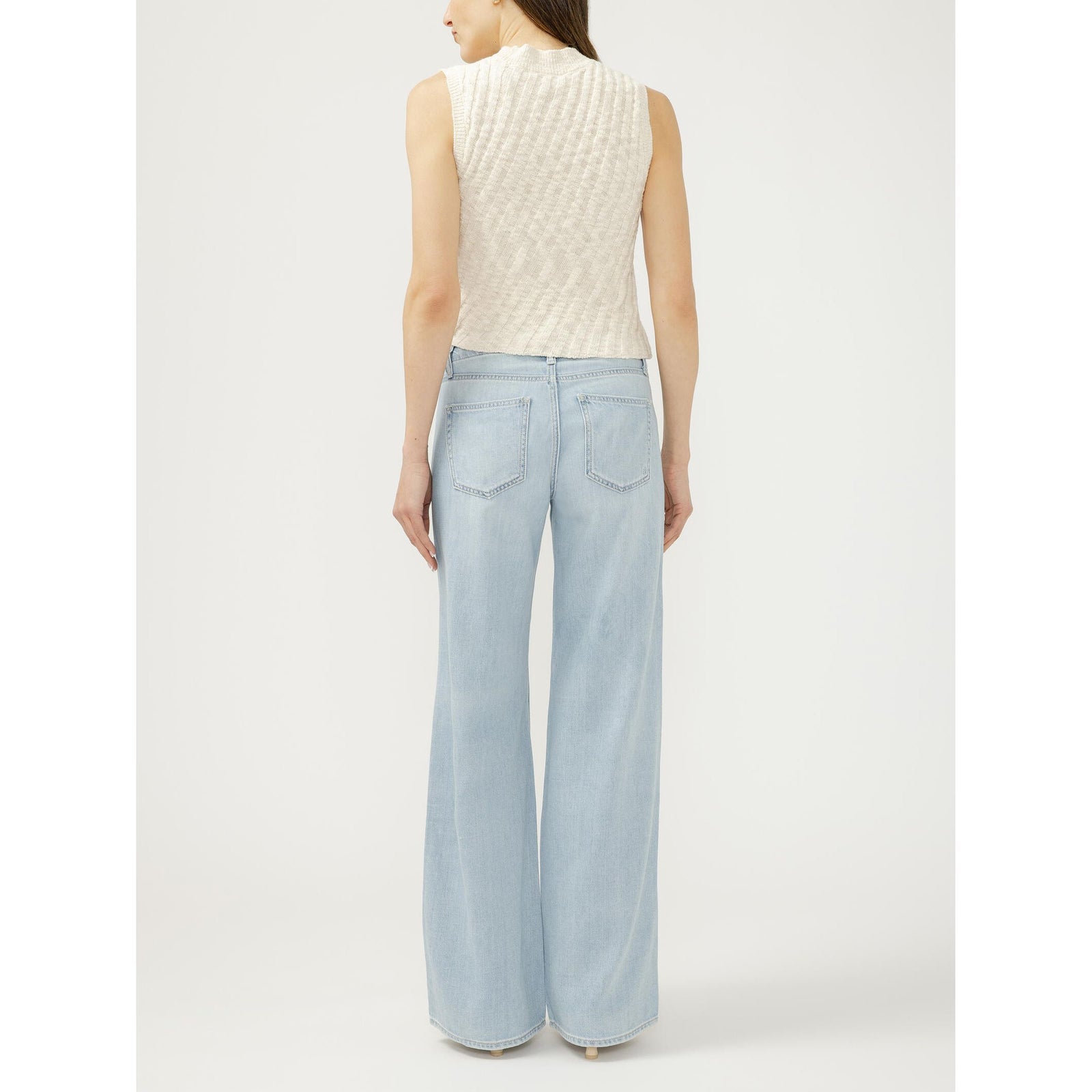 Back view of a model wearing Silver Suki Wide Leg jeans in Dreamer's Edge, mid-rise with contoured waistband.