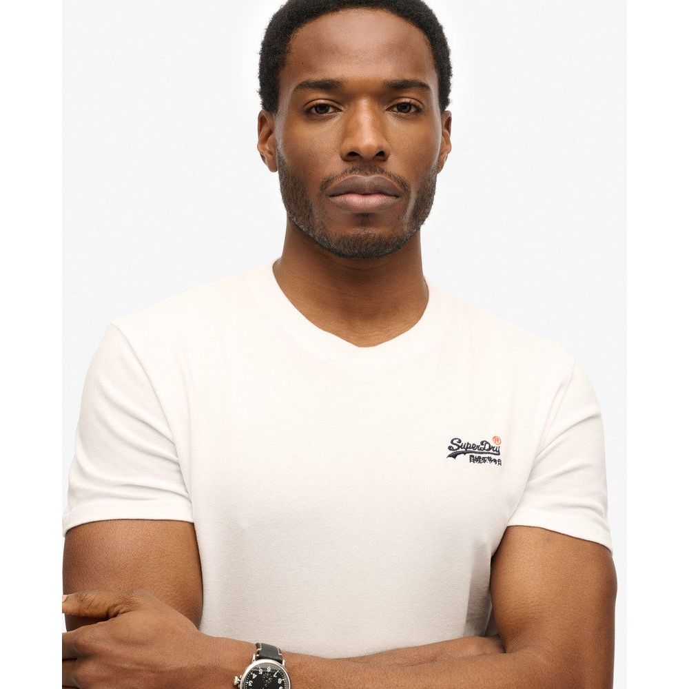 Man wearing white Superdry Essential Embroidered Tee, 100% cotton, with small chest logo.