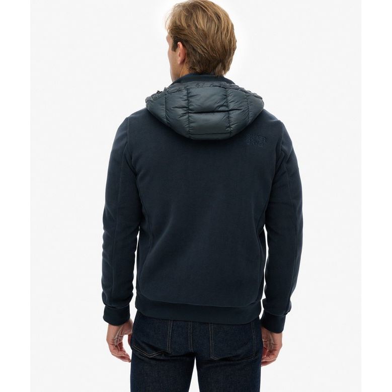 Back view of a man wearing a navy Superdry Hooded Storm Fleece with padded body and plush fleece sleeves.