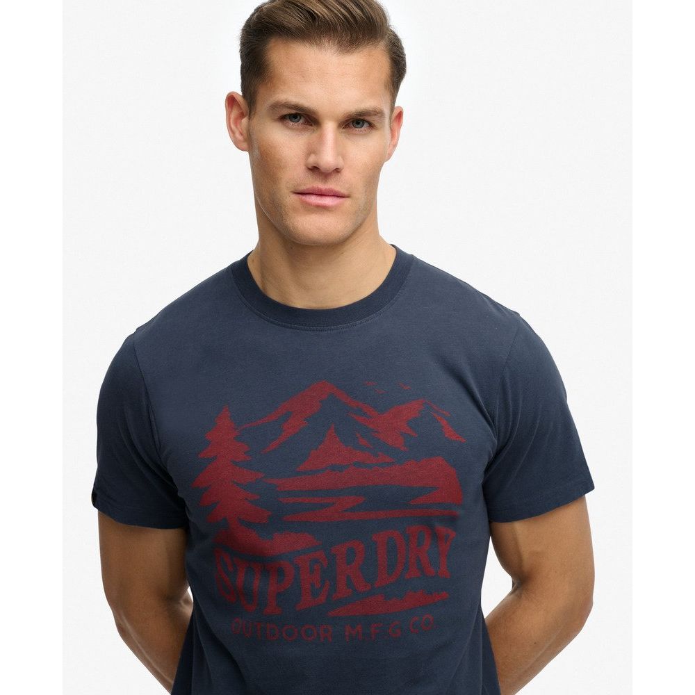 Man wearing navy Superdrydry Retro Outdoor Relaxed Tee with red vintage mountain graphic