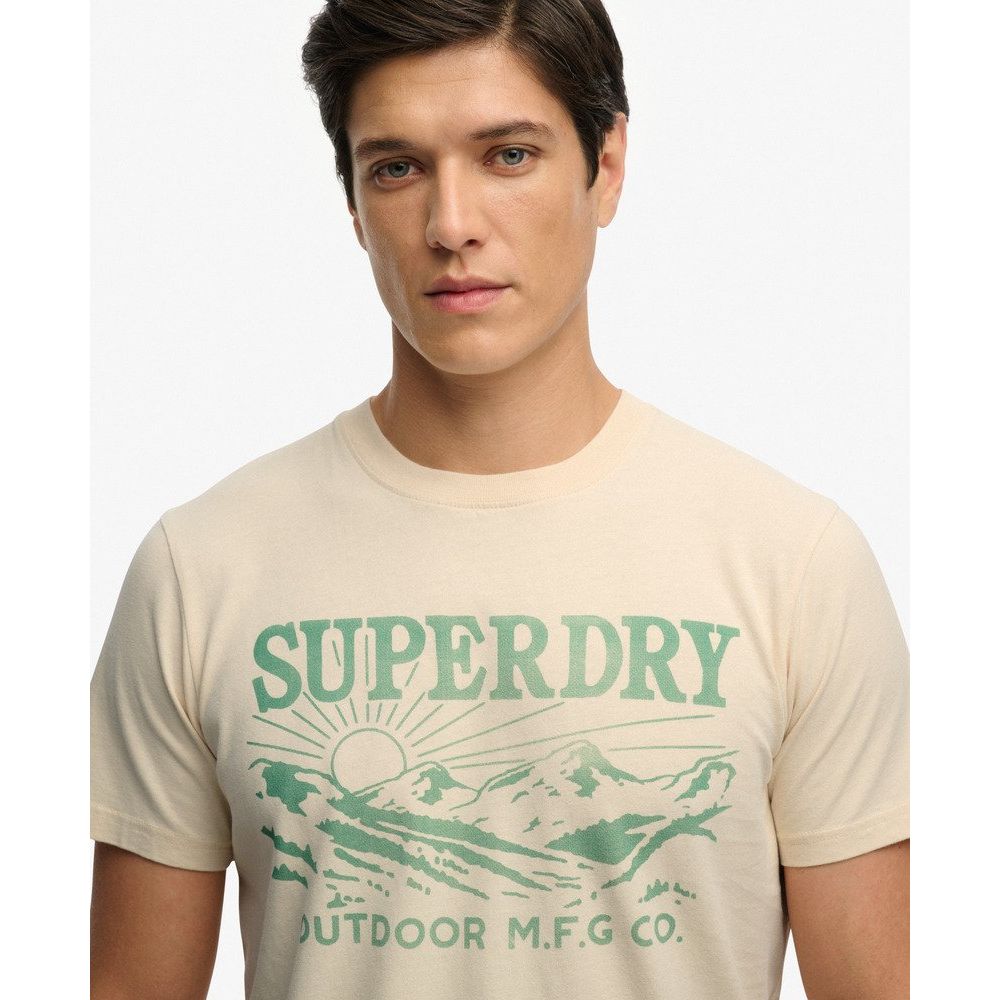 Model wearing beige Superdry Retro Outdoor Relaxed Tee with green vintage mountain graphic.