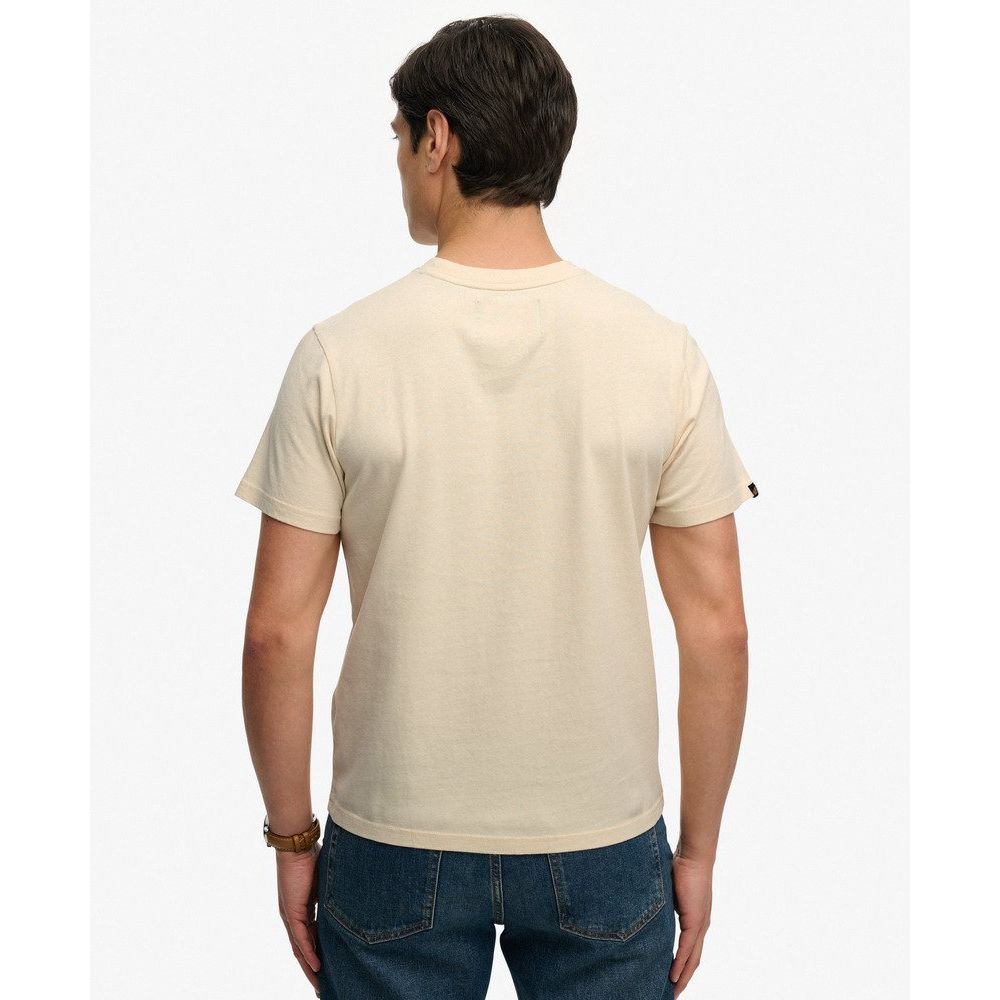 Back view of a man wearing a beige Superdrydry Retro Outdoor Relaxed Tee, short sleeves.