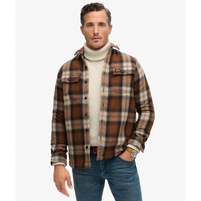 Superdry Roderick Check Wool Miller Overshirt in brown plaid with borg lining worn over cream turtleneck.