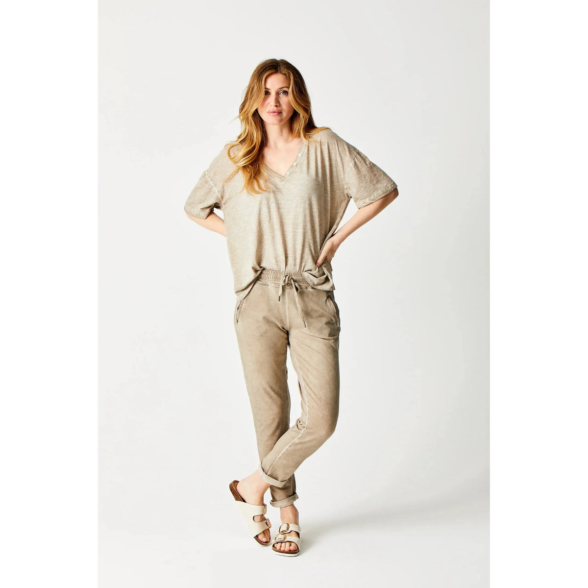 Stylish woman wearing Suzy D Bailey Vintage Wash Side Zip Jogger with chic turn-up hem and zipped pockets.