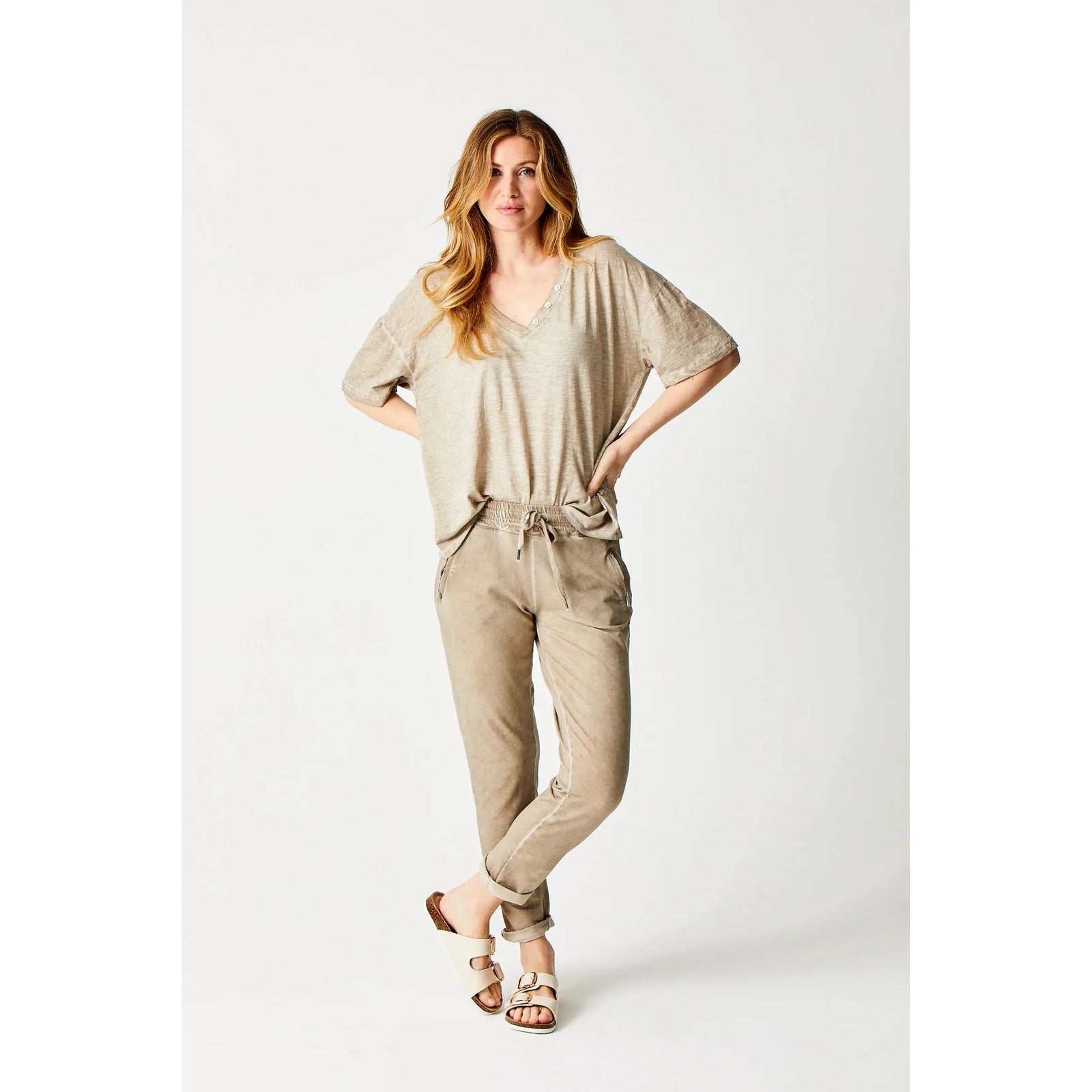 Stylish woman wearing Suzy D Bailey Vintage Wash Side Zip Jogger with chic turn-up hem and zipped pockets.