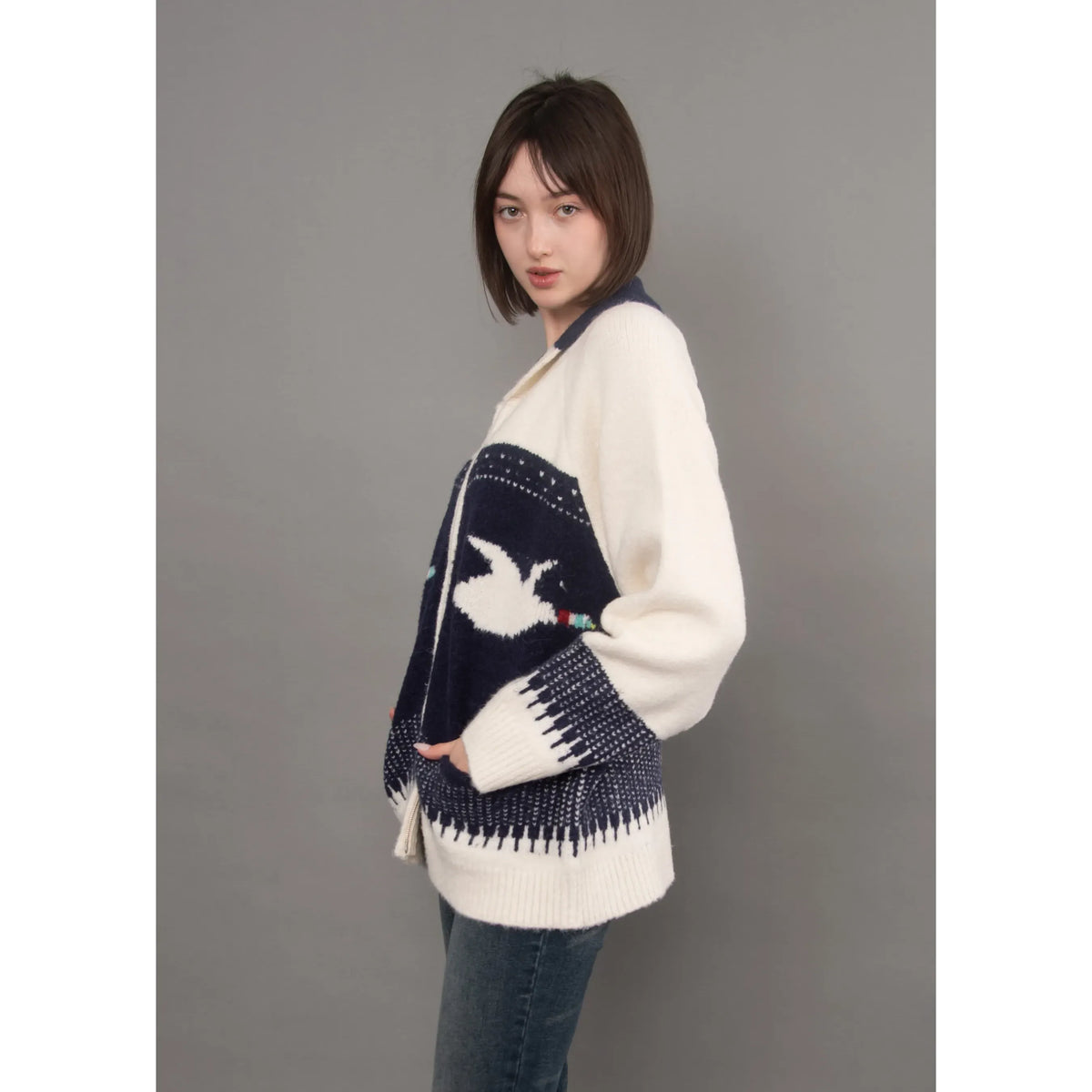 White and navy raglan sleeve cardigan with shawl collar, featuring a knitted dove motif and cozy relaxed fit.