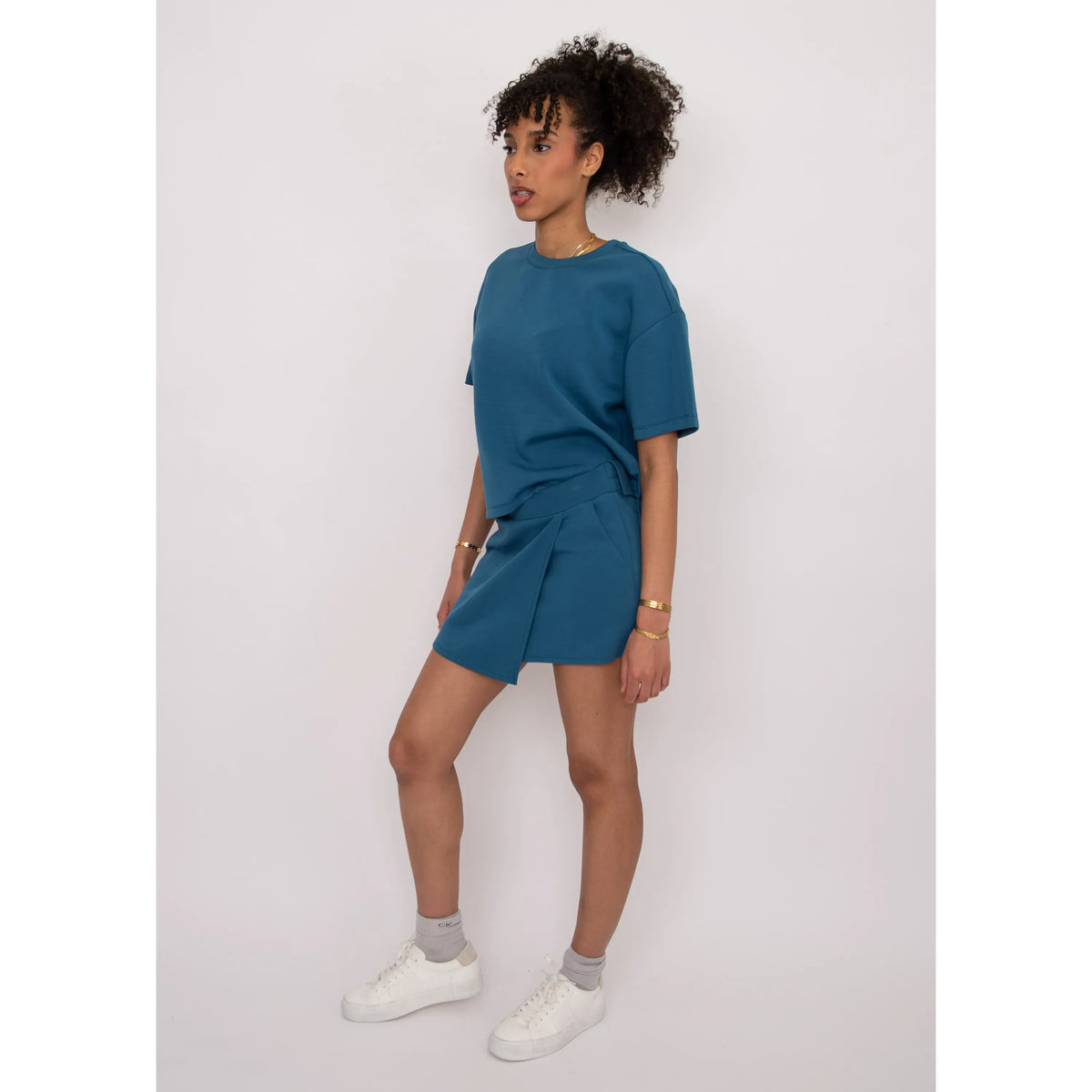 Tess Soft Knit Top in teal, boxy, ultra-soft knit worn by a model in size Small (47% polyester, 43% rayon).