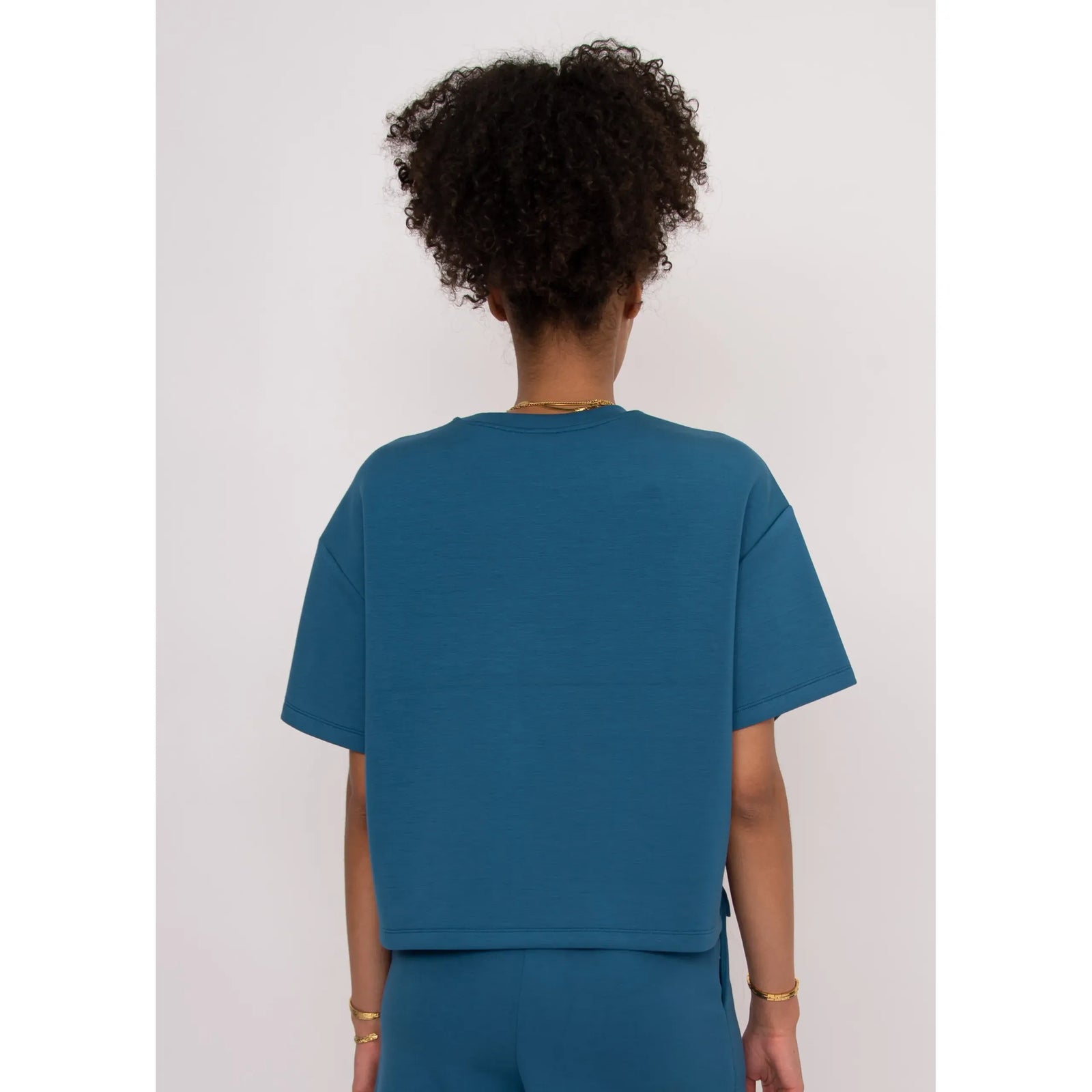 Back view of Tess Soft Knit Top in teal, boxy, short-sleeve cozy knit fabric.