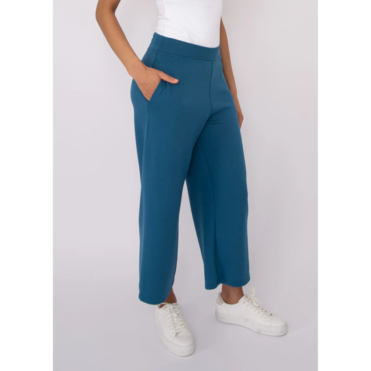 Victoria Soft Knit Cropped Pants in teal with pockets and a roomy wide leg, styled with a white top.