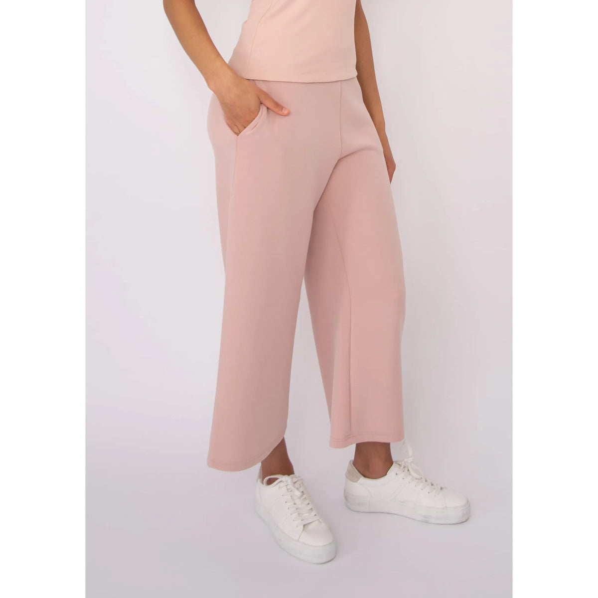 Victoria Soft Knit Cropped Pants in blush pink with pockets and a wide-leg silhouette, worn by a model in size Small.