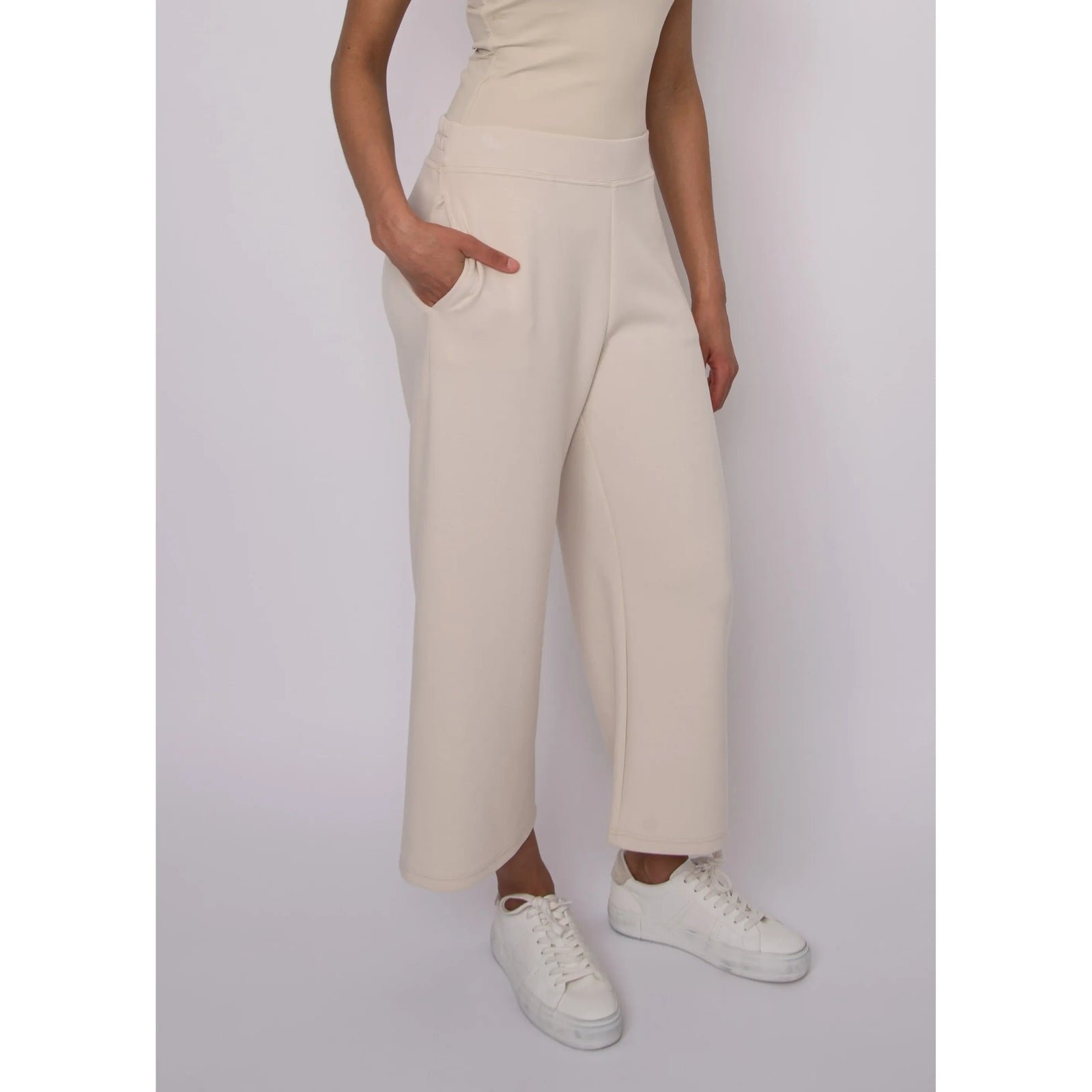 Victoria Soft Knit Cropped Pants in cream, wide-leg knit with pockets, styled with white sneakers.