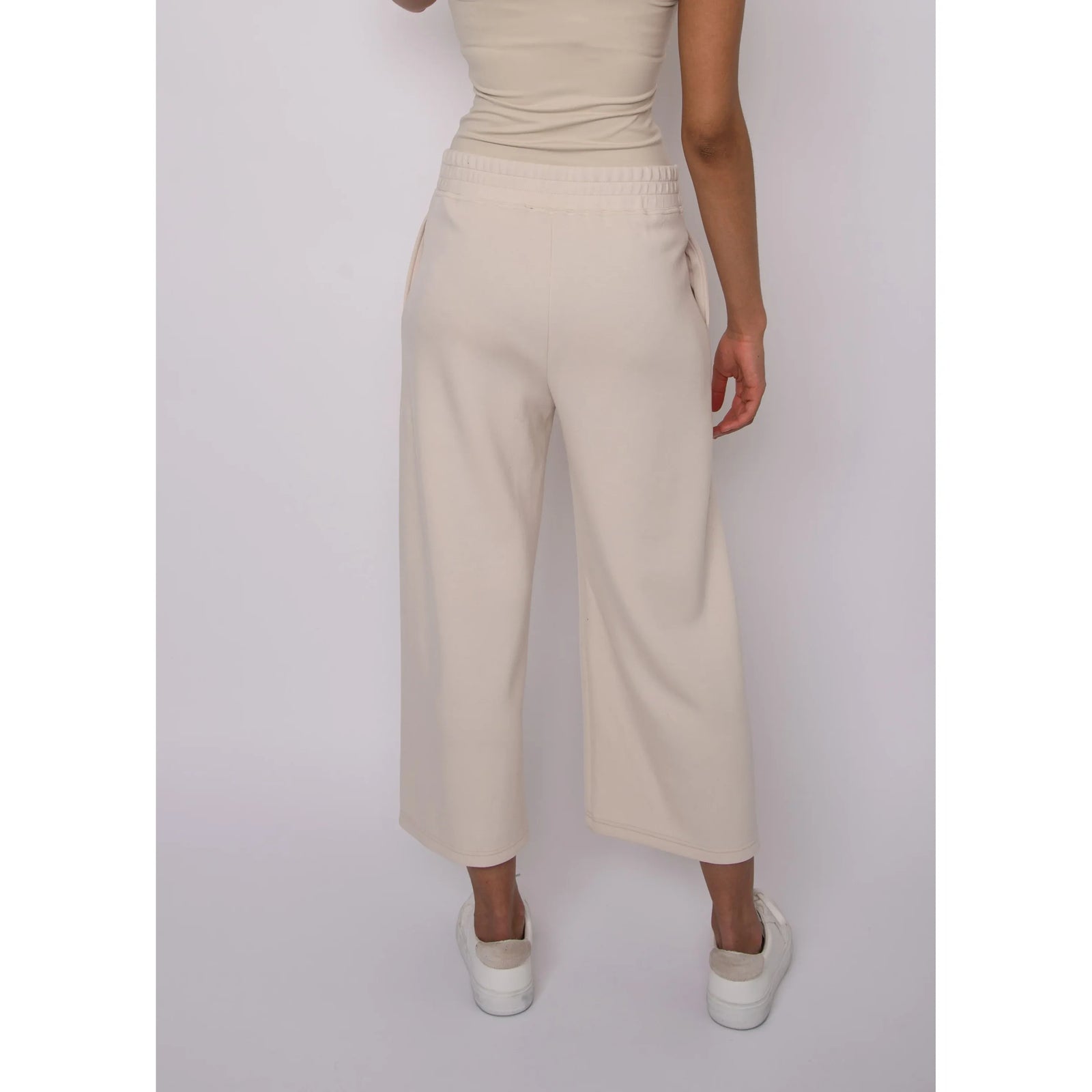 Victoria Soft Knit Cropped Pants in beige, back view with elastic waistband and pockets.