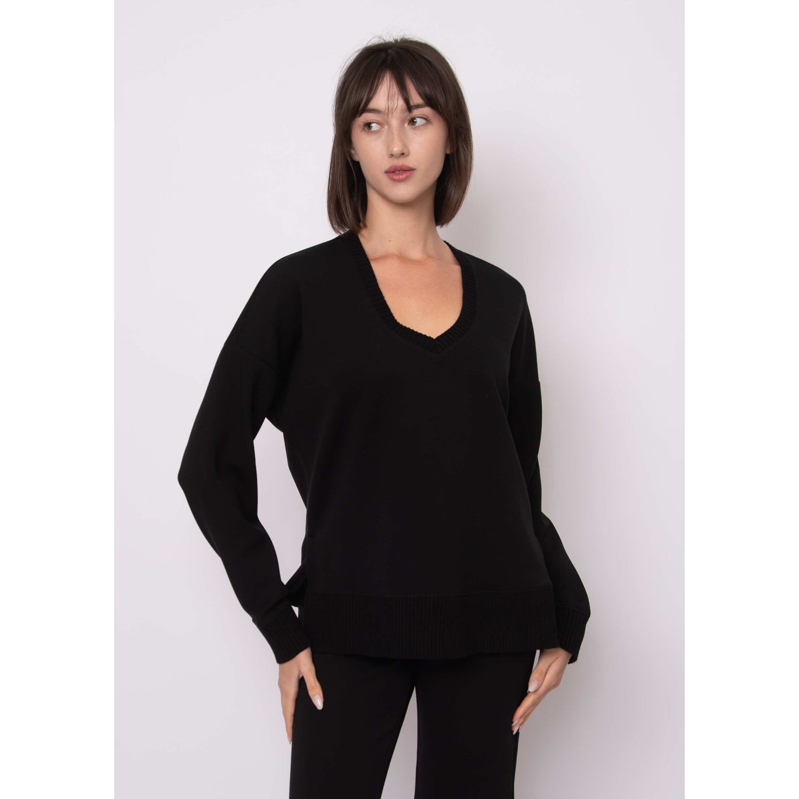 Vixie Soft Knit V-neck Sweater on a model, black with ribbed hem and cuffs.