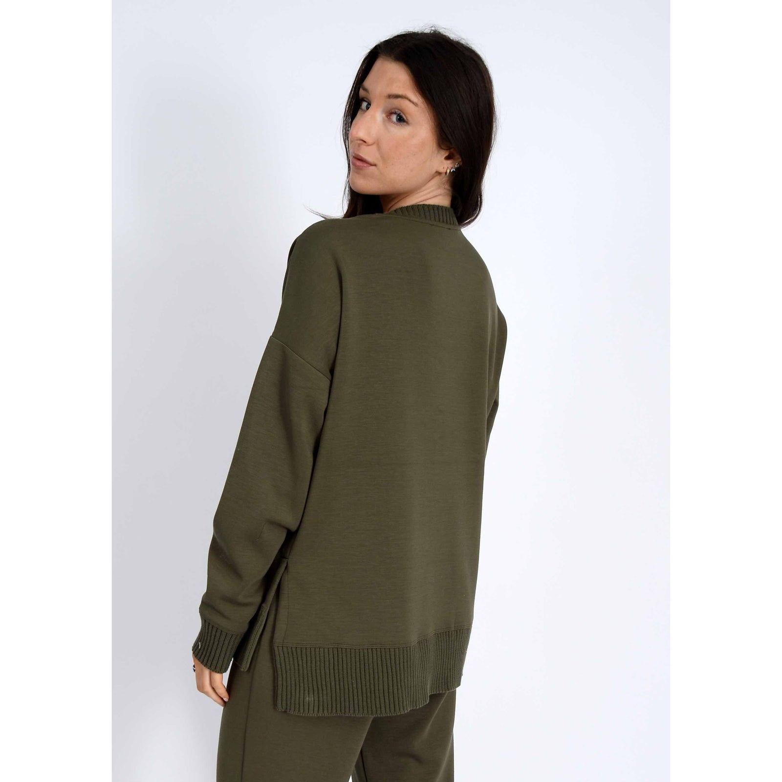 Olive green Vixie Soft Knit V-neck sweater on model with ribbed hem and cuffs
