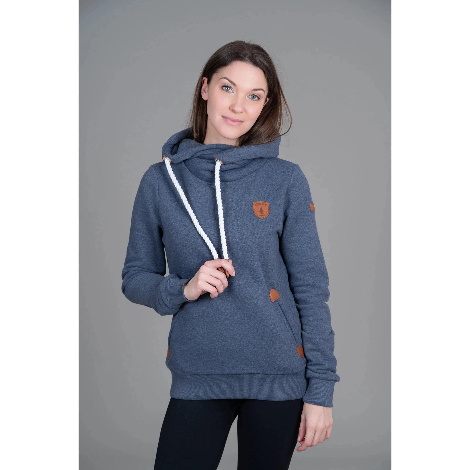 Wanakome Artemis Hoodie navy on a model with white drawstrings and front pockets.