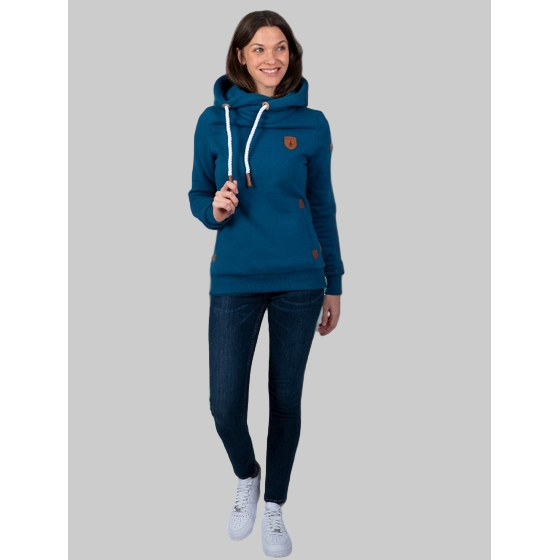 Wanakome Artemis Hoodie in teal blue worn by a model; cozy cowl neck, attached hood, and practical pockets.