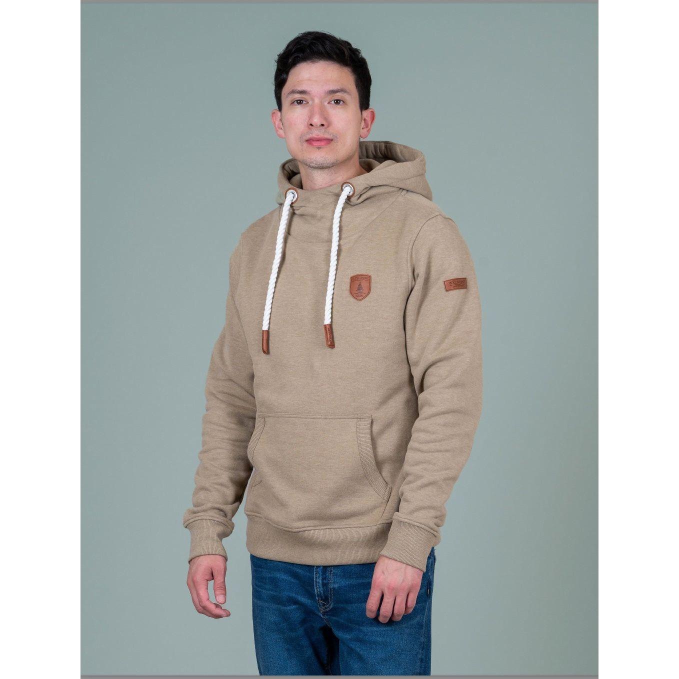 Wanakome Cascade Hoodie worn by Khaleel in size Large; beige fleece, white drawstrings, patch logo, front pocket.