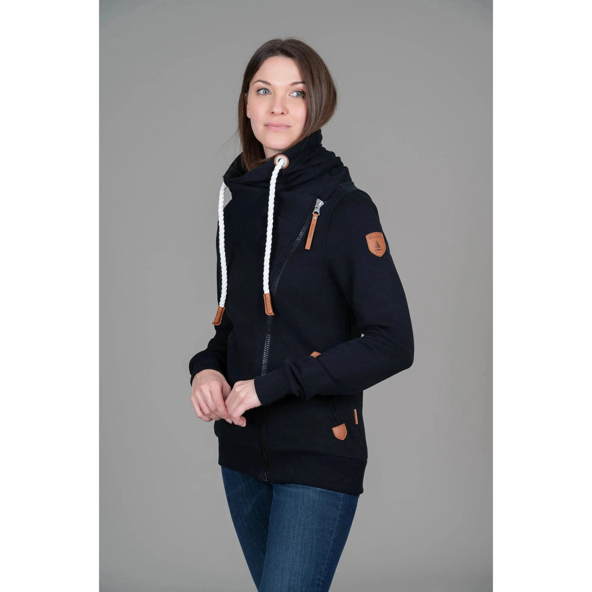 Stylish Wanakome Hestia Zip Up in black, featuring a cozy funnel neck and flattering asymmetrical zipper.