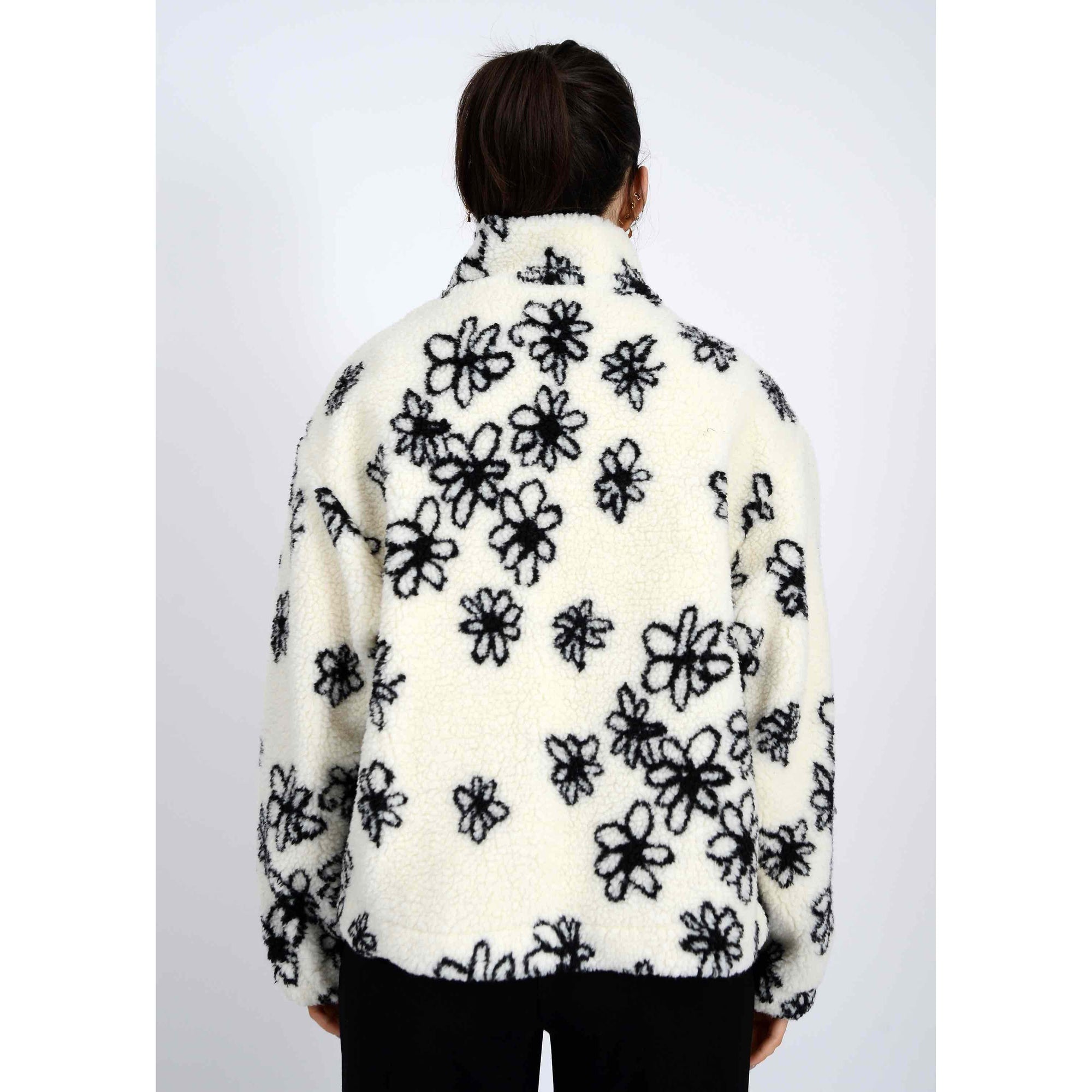 Whistler Sherpa Jacket: white sherpa fleece with black snowflake print, back view of a model.