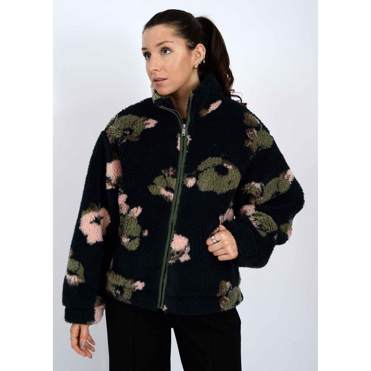 Whistler Sherpa Jacket worn by a model in a black camo fleece with zip closure and high mock collar.