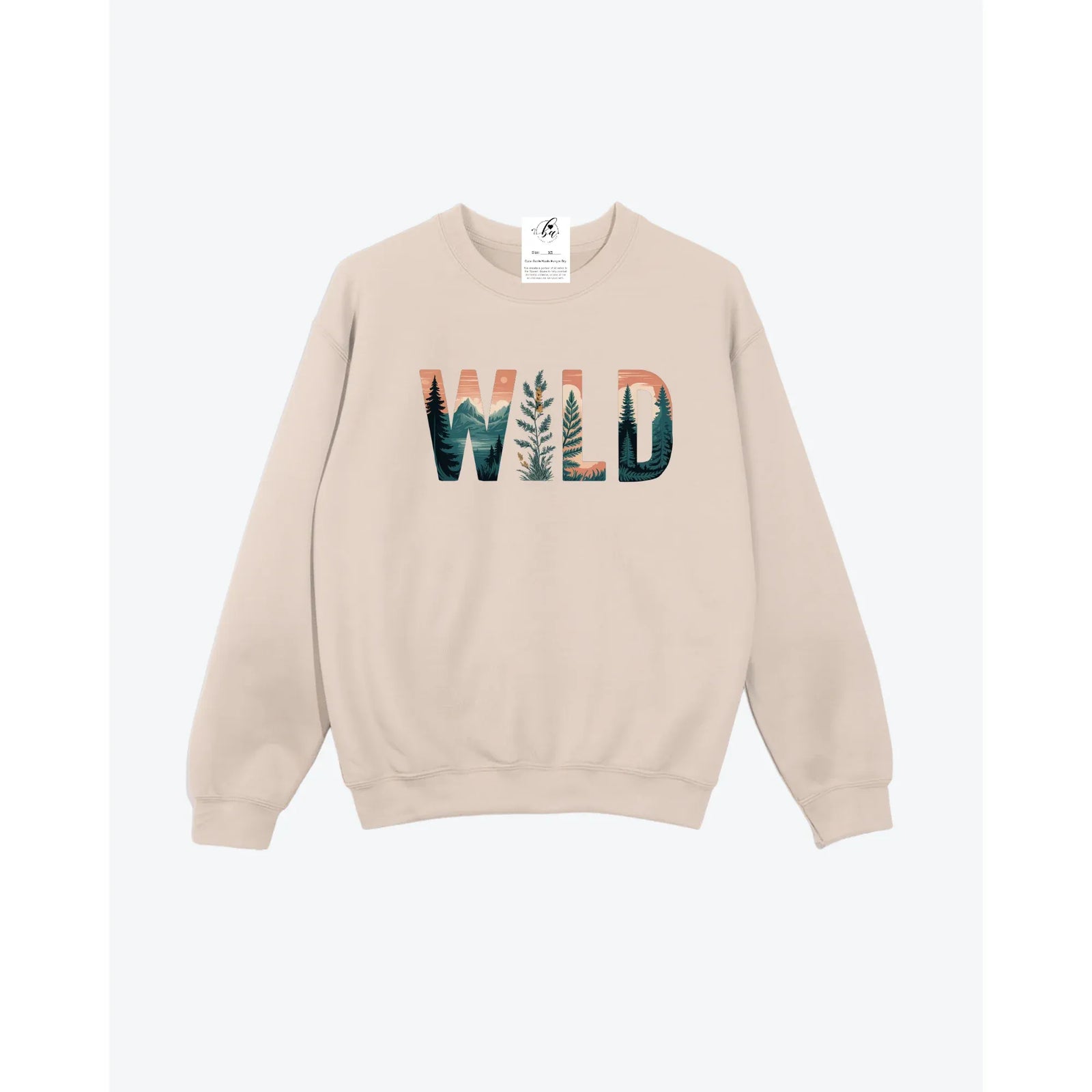 Wild Cozy Crew beige crewneck sweater with forest landscape inside WILD lettering, unisex fit.
